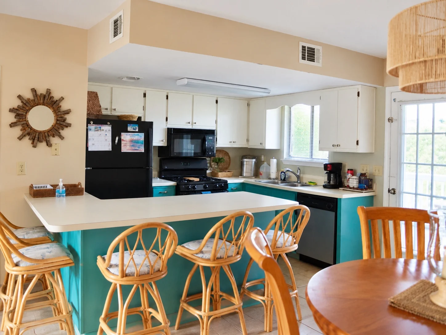 Current kitchen and dining area at Baker's Tide with turquoise breakfast bar