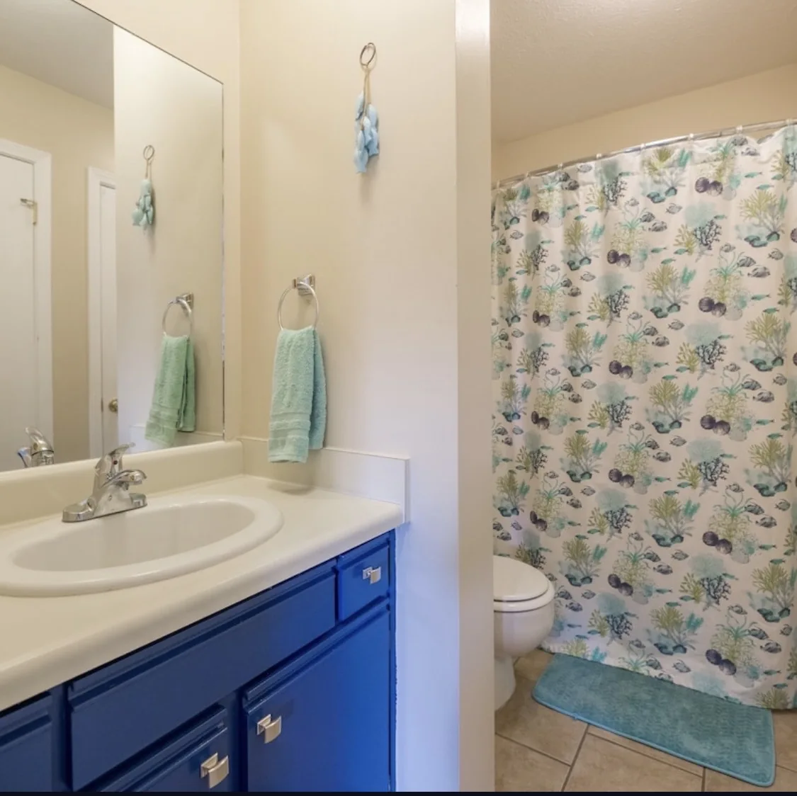 Main bathroom at Baker's Tide with blue vanity